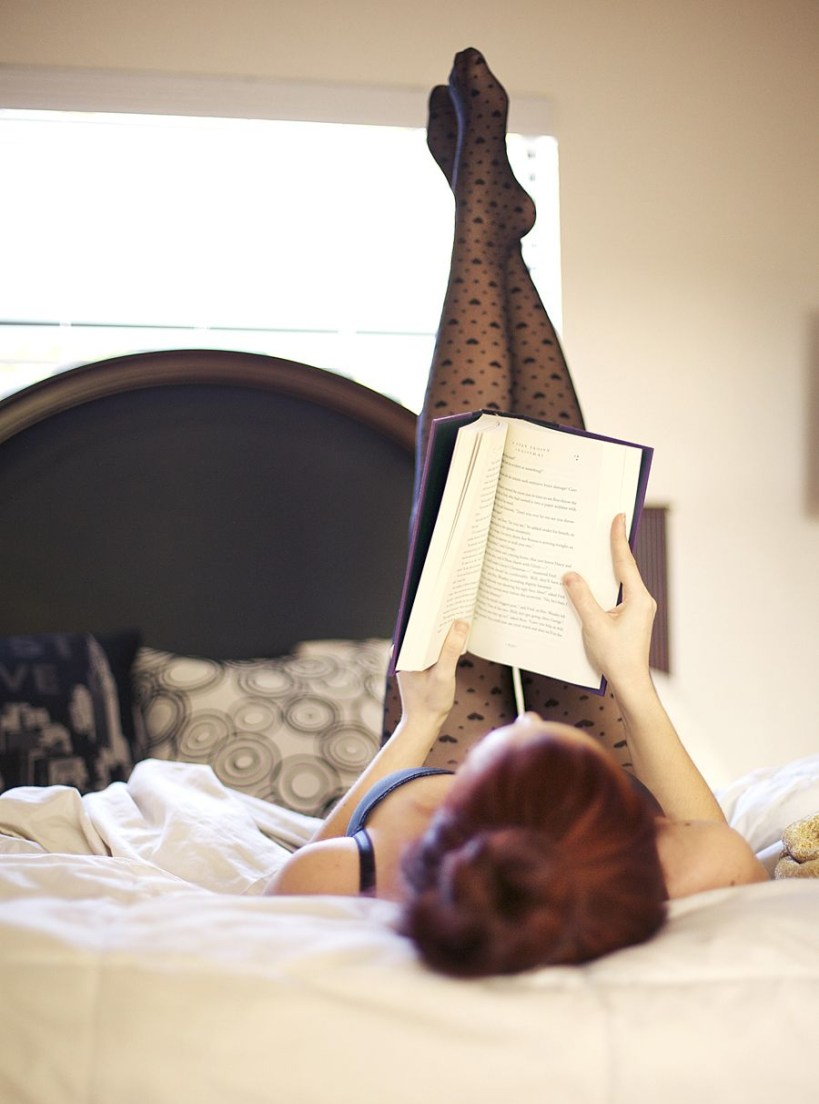 girl on bed reading book